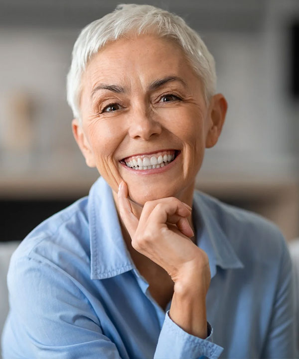 Smiling woman with dental implants in Downey